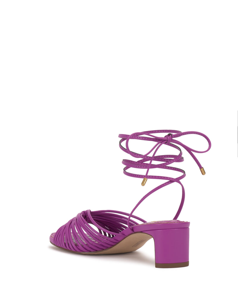 The Lory Kitten Heel Sandal by Vince Camuto features a purple strappy ankle-tie design with wrap-around laces and a block kitten heel, shown from the back on a white background.
