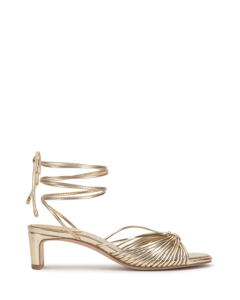 The Vince Camuto Lory Kitten Heel Sandal is shown in gold with strappy design and elegant wraparound ankle ties, displayed in a side profile view on a white background.