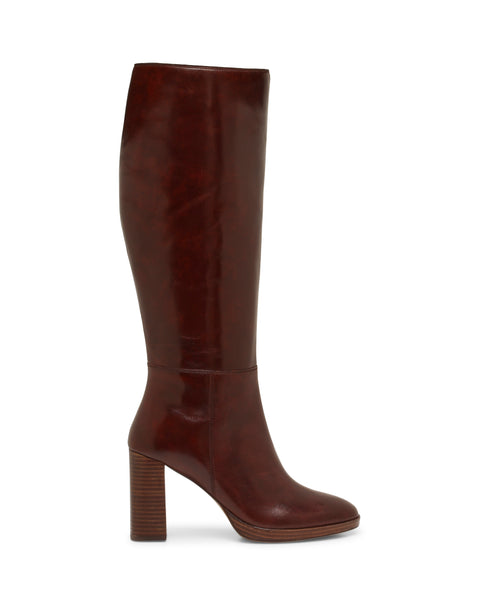 The Vince Camuto Lucina Knee High Boot is shown in profile on a white background, featuring a tall silhouette crafted from brown leather, a rounded toe, and a high chunky block heel.