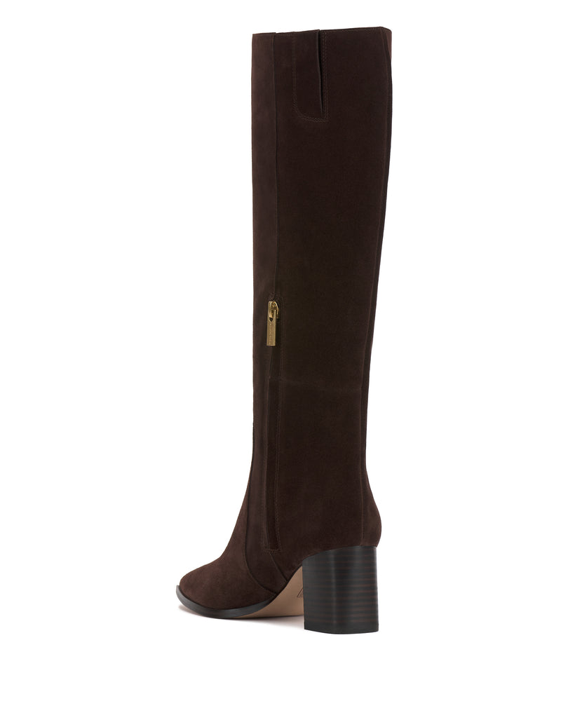 The Vince Camuto Lumina Extra Wide Calf Knee High Boot is a tall, dark brown suede boot with a chunky stacked heel and gold side zipper, shown from the side against a white background.