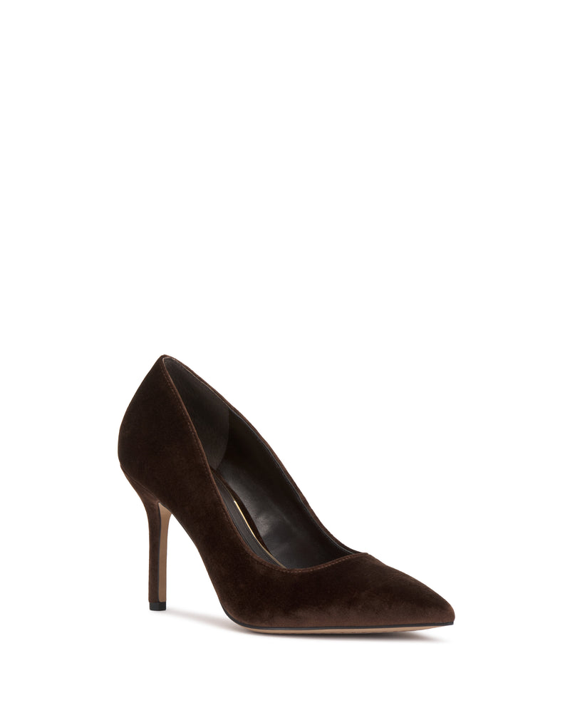The Maisha Pump by Vince Camuto is a dark brown suede high-heeled shoe featuring a pointed toe and slender stiletto heel, shown against a white background.