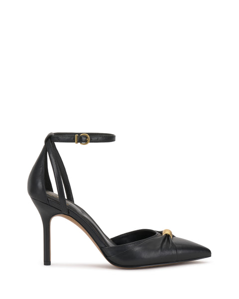 The Vince Camuto Mallie Pump features a black pointed toe, ankle strap with gold buckle, side cutouts, and a stiletto heel. Displayed on a white background.