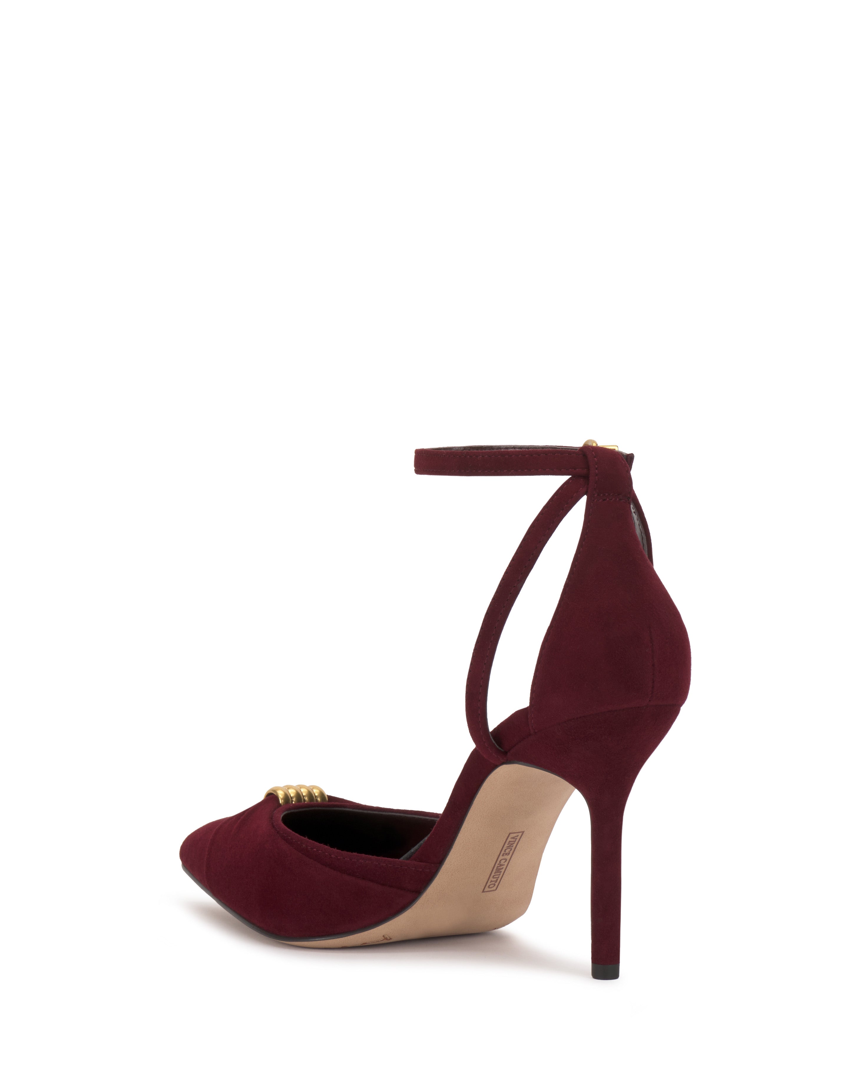 The Vince Camuto Mallie Pump showcases a pointed toe, ankle strap, and gold buckle in rich burgundy, set against a white background.