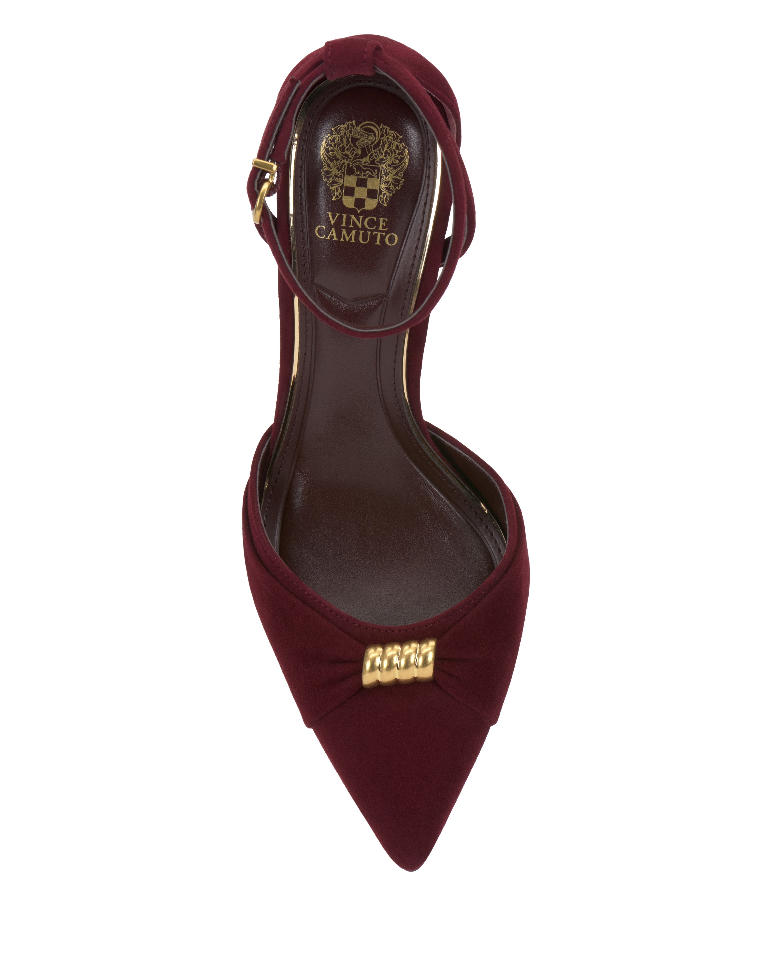 Top view of the Vince Camuto Mallie Pump: a burgundy pointed-toe women’s shoe with an ankle strap, gold logo on the insole, and a decorative bow with a gold accent on the front. Brand name visible inside.