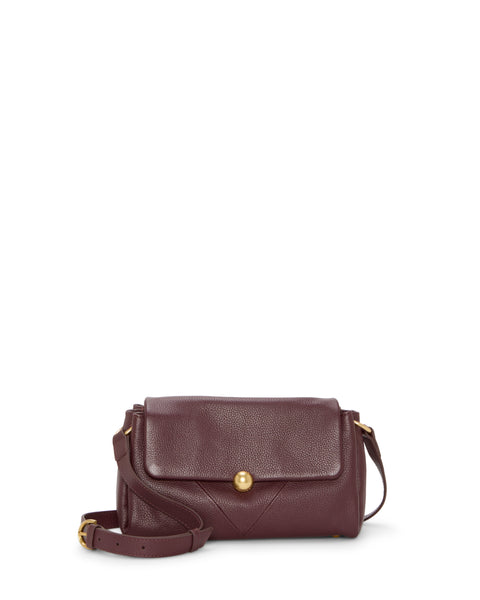 The Vince Camuto Medna Crossbody Bag is a small, rectangular burgundy leather bag with a flap closure, gold button clasp, adjustable shoulder strap, and a minimal design.