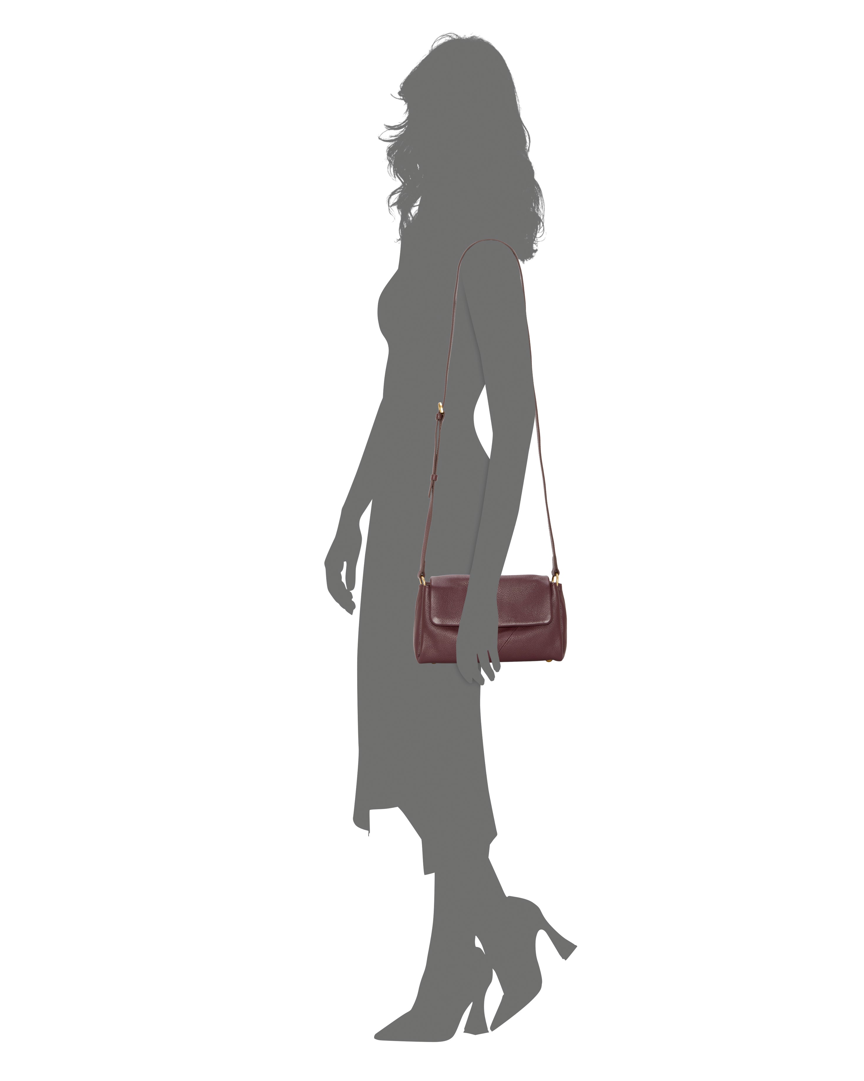 A woman in a mid-length dress and heels carries the Vince Camuto Medna Crossbody Bag with a long strap, shown against a white background.