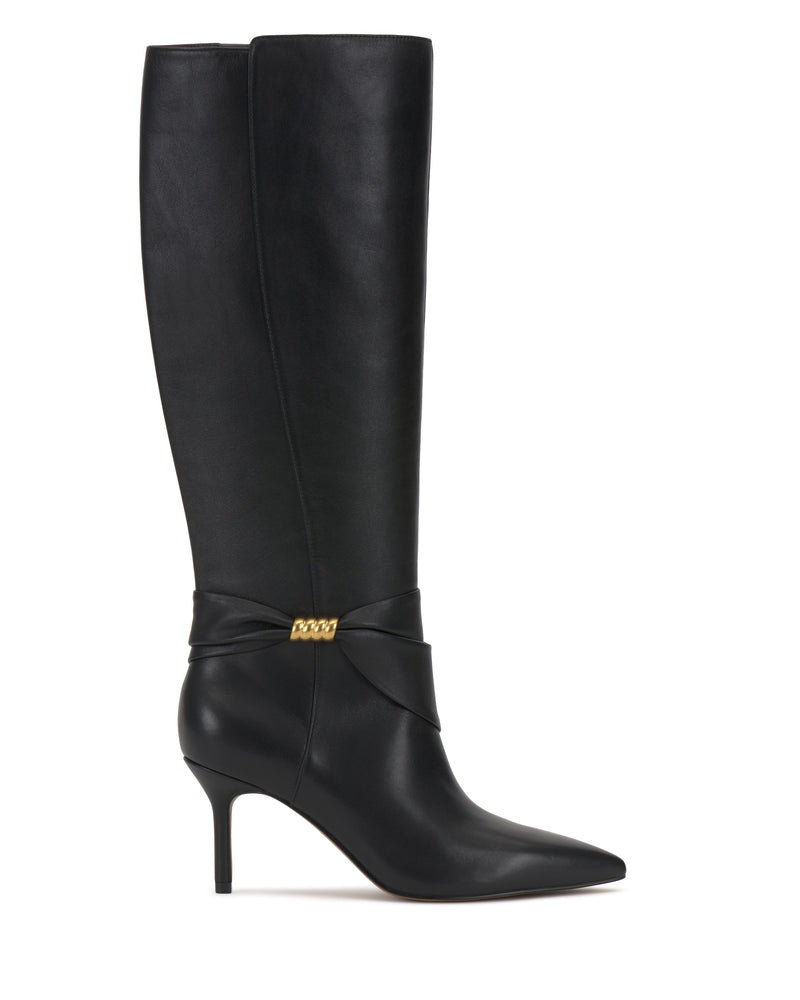 The Vince Camuto Meezo Narrow Calf Knee High Boot is a tall black leather boot with a pointed toe, skinny heel, and a gold hardware chain accent near the ankle.
