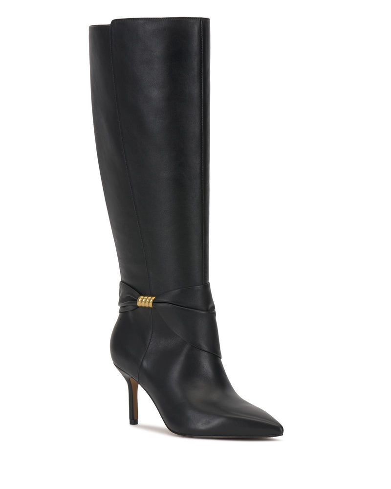 The Meezo Extra Wide Calf Knee High Boot by Vince Camuto is a tall black leather boot with a pointed toe, skinny heel, and twisted strap detail around the ankle accented by gold hardware.