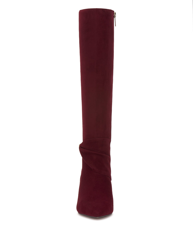 The Vince Camuto Meezo Extra Wide Calf Knee High Boot is a tall burgundy suede boot with a skinny heel, side zipper, and ankle wrap detail, shown from the front on a white background.