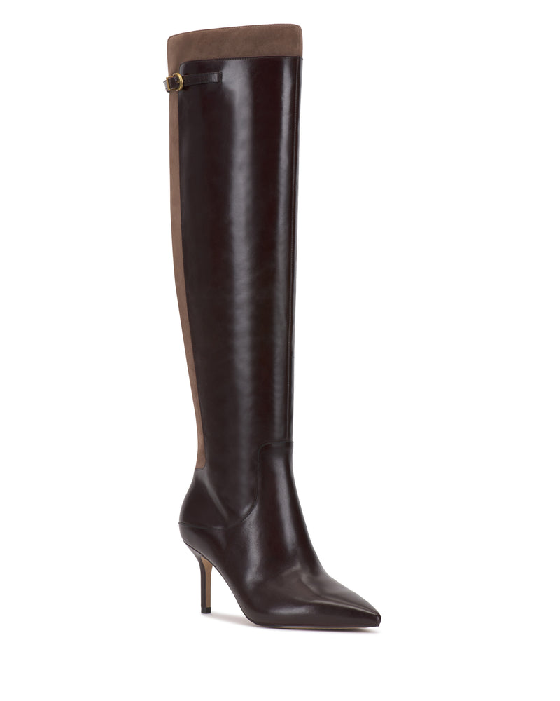 The Meleis Narrow Calf Over the Knee Boot by Vince Camuto features knee-high black leather with a pointed toe, stiletto heel, brown suede panel at the top and back, and a small buckle detail near the top.
