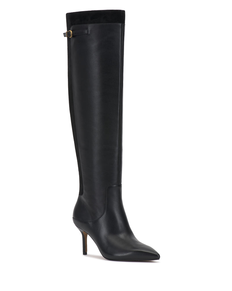 The Meleis Wide Calf Over the Knee Boot by Vince Camuto features tall black leather, a pointed toe, a slim heel, and a small strap detail with a gold buckle near the top. The boot is displayed against a white background.