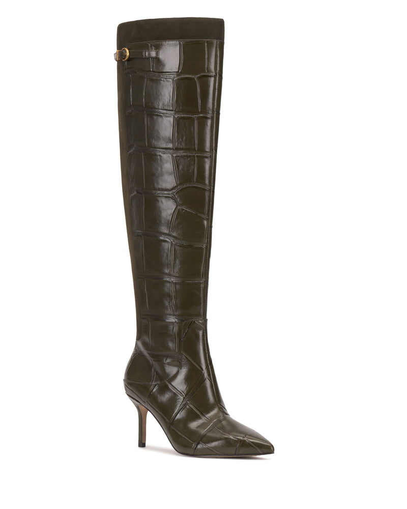 The Meleis Wide Calf Over the Knee Boot by Vince Camuto features dark green, crocodile-embossed leather, a pointed toe, a slim high heel, and a small strap with a gold buckle near the top.