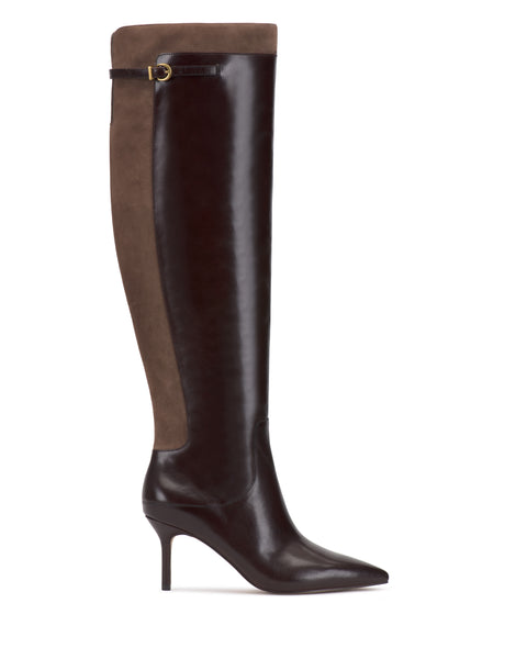The Meleis Over the Knee Boot by Vince Camuto is a knee-high style featuring a pointed toe and high heel, with a dark brown leather front, a lighter brown suede back, and a small buckle detail near the top.