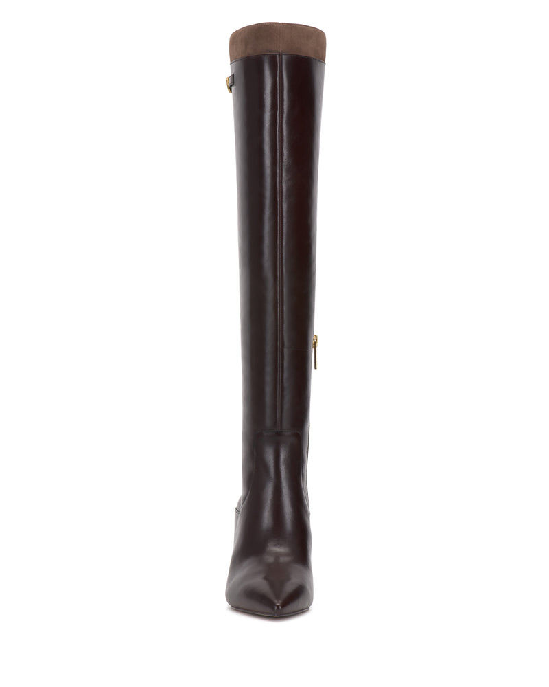 The Vince Camuto Meleis Over the Knee Boot is a tall, dark brown leather boot with a pointed toe, a visible side zipper, and a light brown cuff at the top, displayed facing forward against a white background.