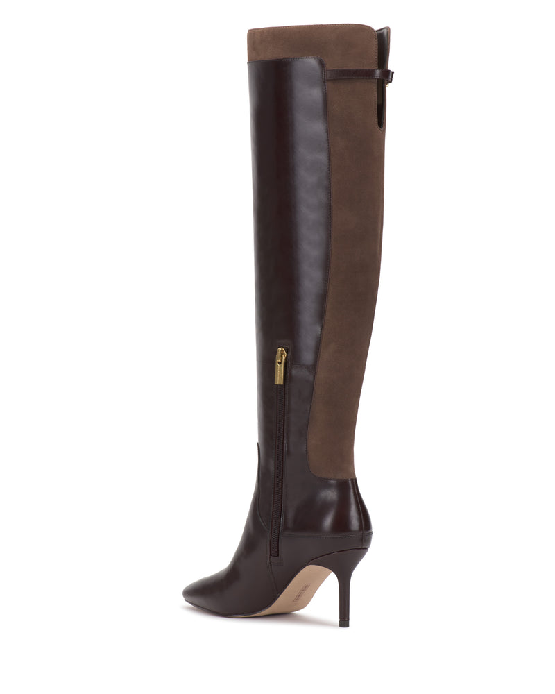 The Meleis Over the Knee Boot by Vince Camuto features a brown design with a pointed toe, stiletto heel, side zipper, and contrasting leather and suede panels.