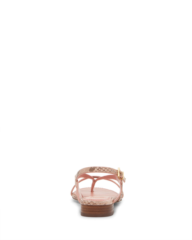 The Vince Camuto Melly Sandal is a flat slingback viewed from the back, featuring light pink patterned leather straps and a small gold buckle on the right side, shown against a white background.