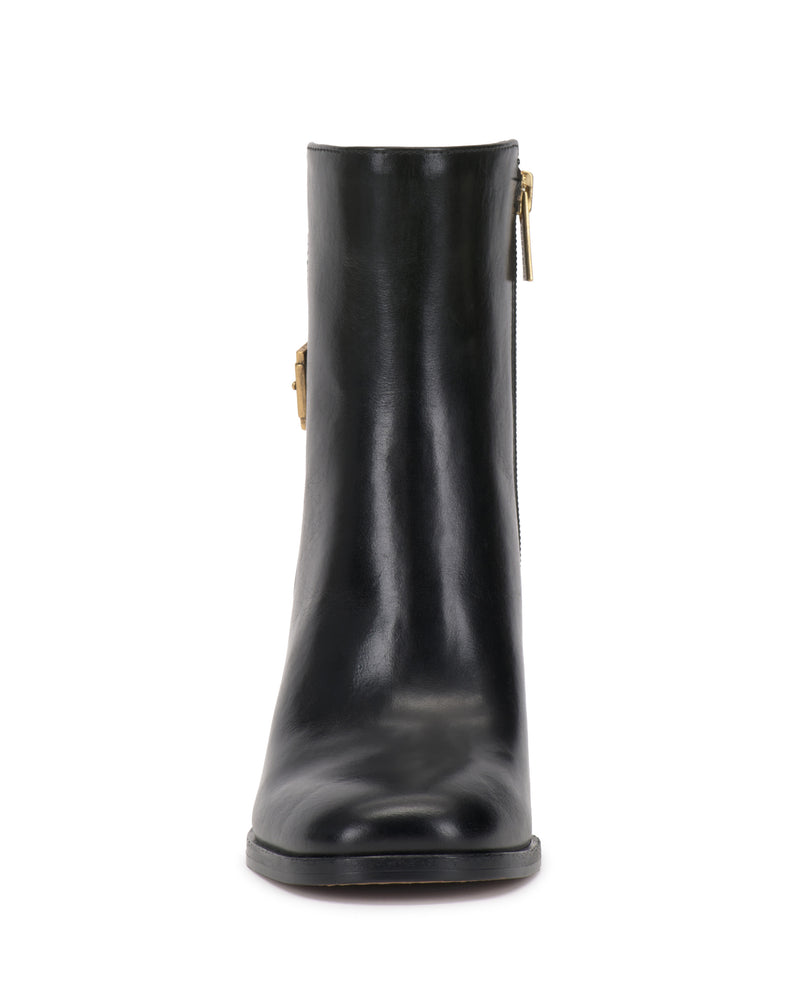 Front view of the Vince Camuto Melvani Bootie in black leather, showcasing a slight shine, a rounded toe, a visible side zipper with a gold pull, and a low heel. The boot is set against a plain white background.