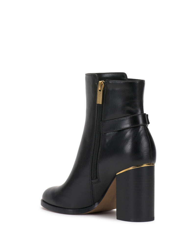 Introducing the Melvani Bootie by Vince Camuto: a black leather ankle boot featuring a chunky high heel, gold side zipper, and a decorative strap around the back. The sole boasts a slight platform, while the heel is finished with a subtle gold accent.