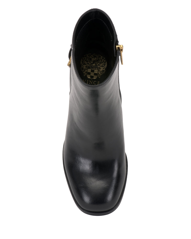 A top view of the Vince Camuto Melvani Bootie in black leather showcases a rounded toe, smooth finish, gold side zipper, and a decorative logo printed on the insole.