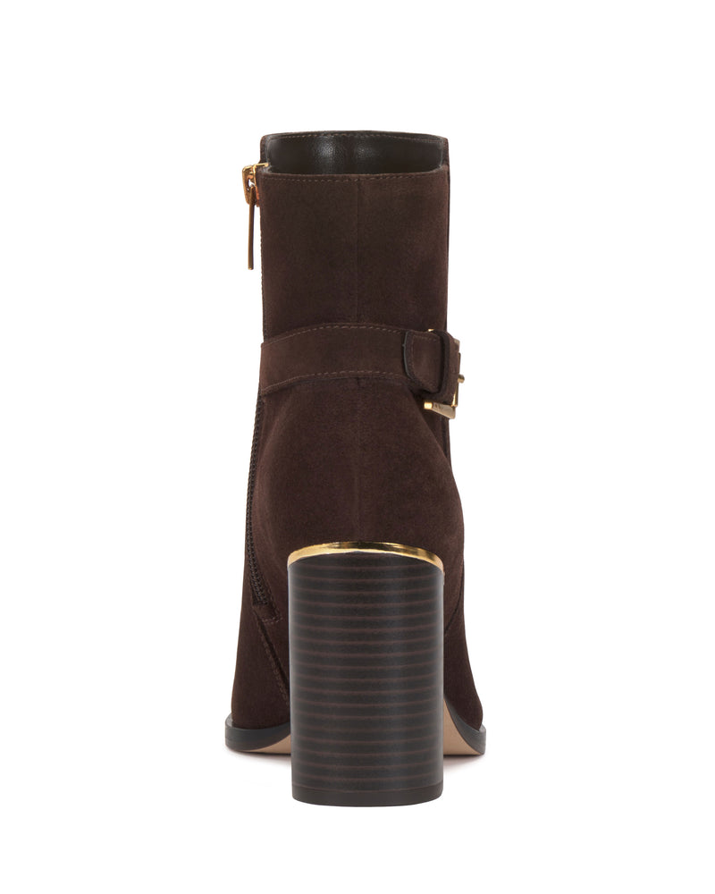 A back view of the Vince Camuto Melvani Bootie in brown suede, featuring a stacked block heel, gold hardware accents, a side zipper, and a decorative ankle strap with a buckle.
