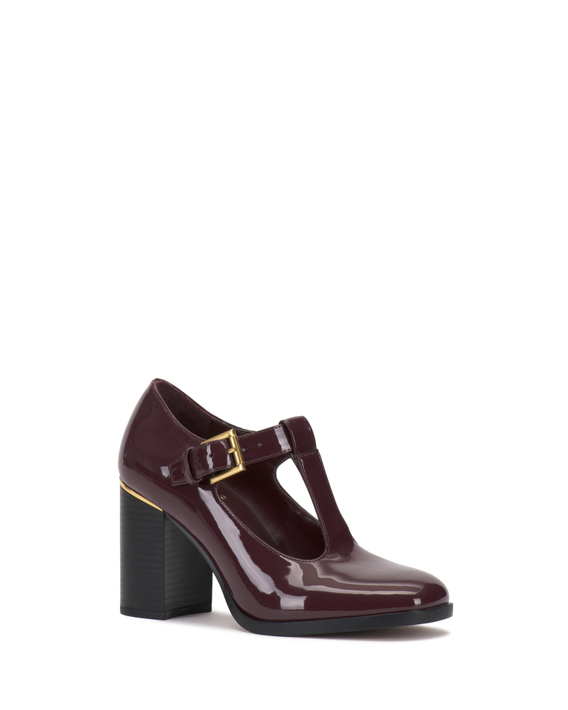 The Vince Camuto Micha Pump is a glossy burgundy T-strap high heel featuring a chunky heel, buckle closure, and gold accent near the heel, exuding vintage charm and feminine style against a white background.