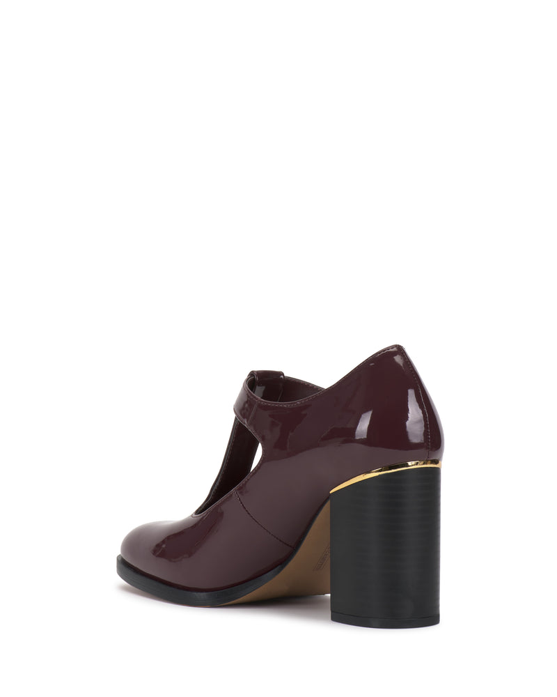 The Micha Pump by Vince Camuto features a glossy burgundy T-strap design with a thick block heel, vintage-inspired charm, and elegant gold detailing near the heel base—perfect for elevating your feminine style.