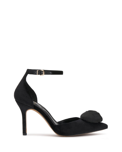 The Mirezzo Pump by Vince Camuto is a black high-heeled shoe featuring a closed pointed toe, chic ankle strap with small buckle, stiletto heel, and a decorative front bow.
