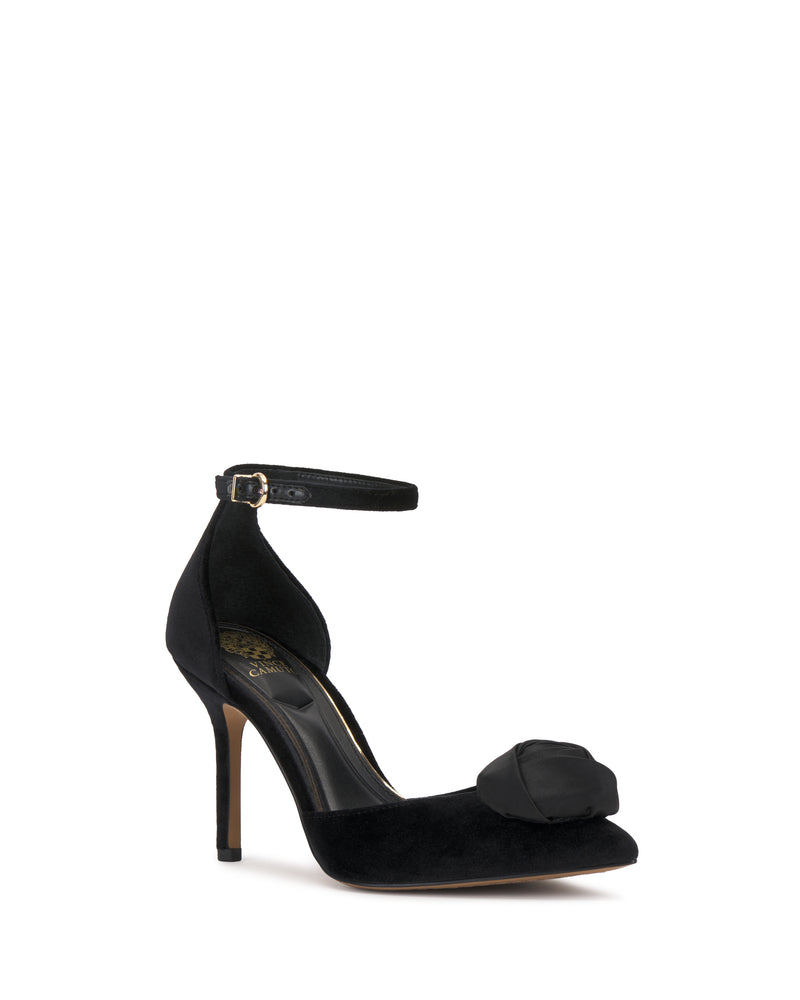 The Mirezzo Pump by Vince Camuto is a black high heel featuring a pointed toe, stiletto heel, ankle strap with buckle, and a decorative bow on the front.