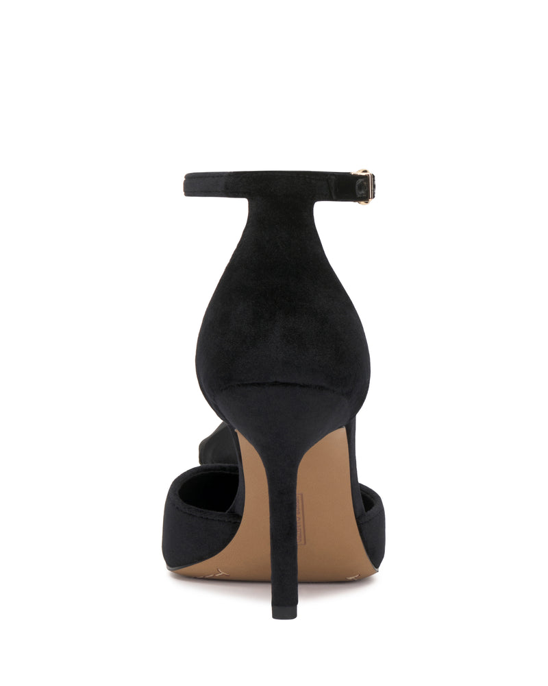 The Mirezzo Pump by Vince Camuto is a black stiletto sandal with an ankle strap and small buckle, closed heel, and a tan sole, viewed from the back.
