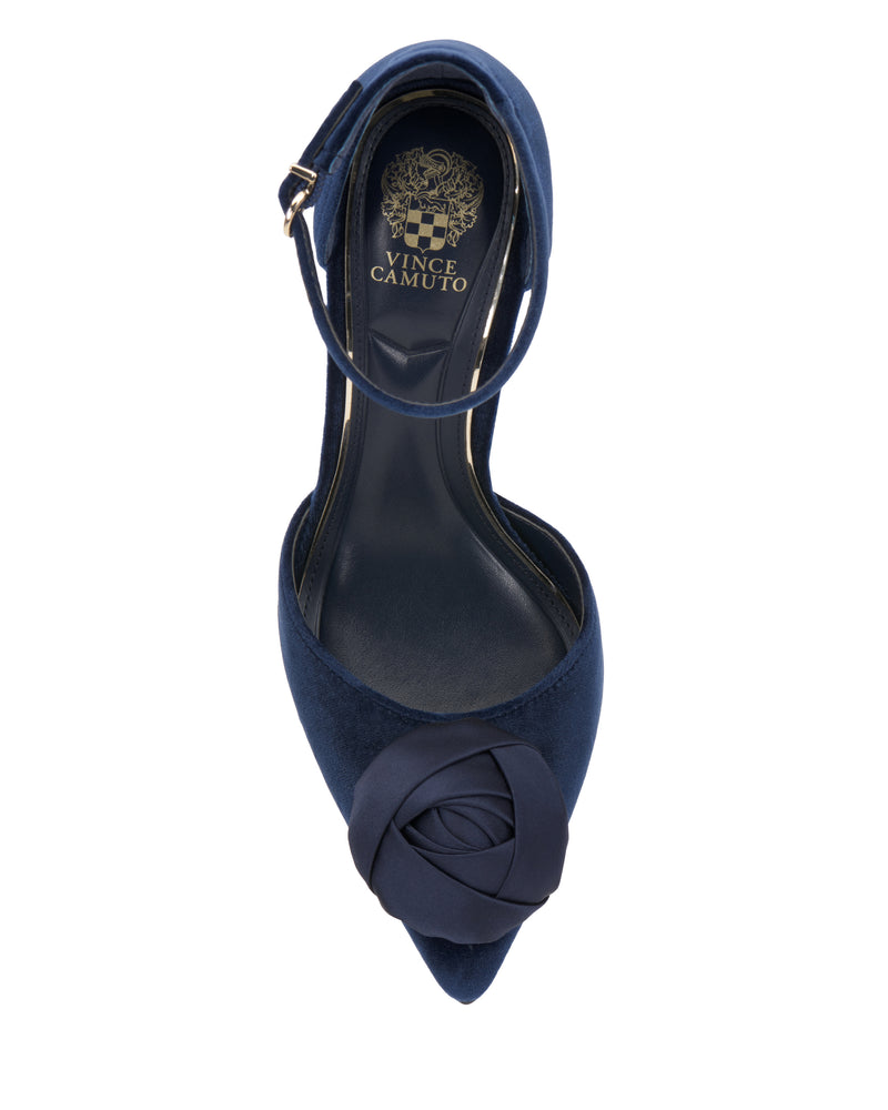 Navy blue pointed-toe Mirezzo Pump by Vince Camuto featuring an ankle strap, stiletto heel, and a decorative fabric rose on the toe. The insole displays the Vince Camuto logo in gold.