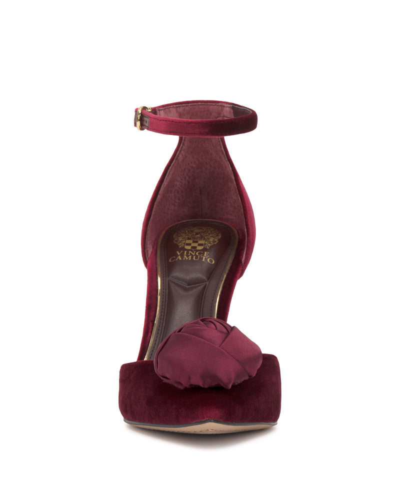 Front view of the Mirezzo Pump by Vince Camuto in burgundy velvet, showcasing an ankle strap, stiletto heel, and a decorative knot on the toe.