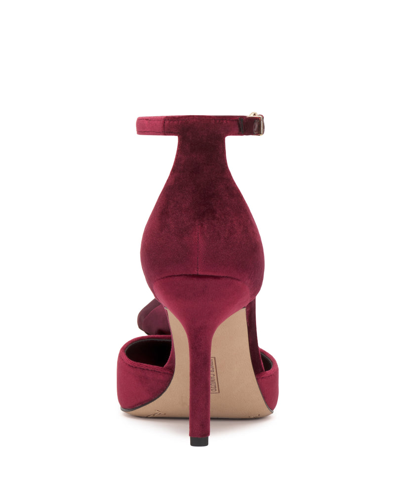 A back view of a single Vince Camuto Mirezzo Pump in deep red velvet, featuring an ankle strap and stiletto heel, shown against a white background.