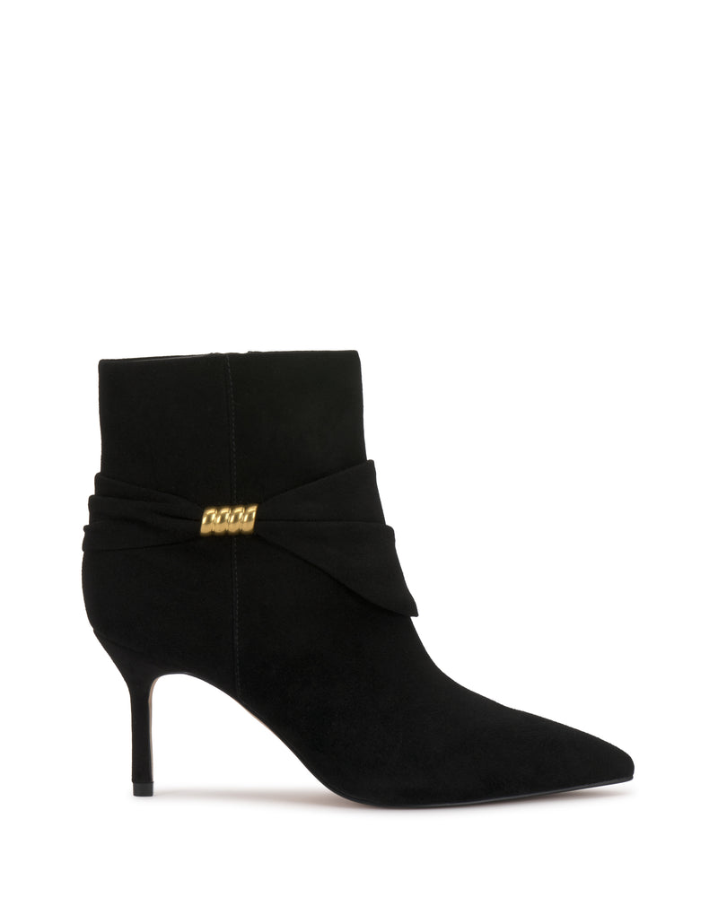 The Murlea Bootie by Vince Camuto features black suede, a pointed toe, mid stiletto heel, and a wrap detail with a gold accent on the side.
