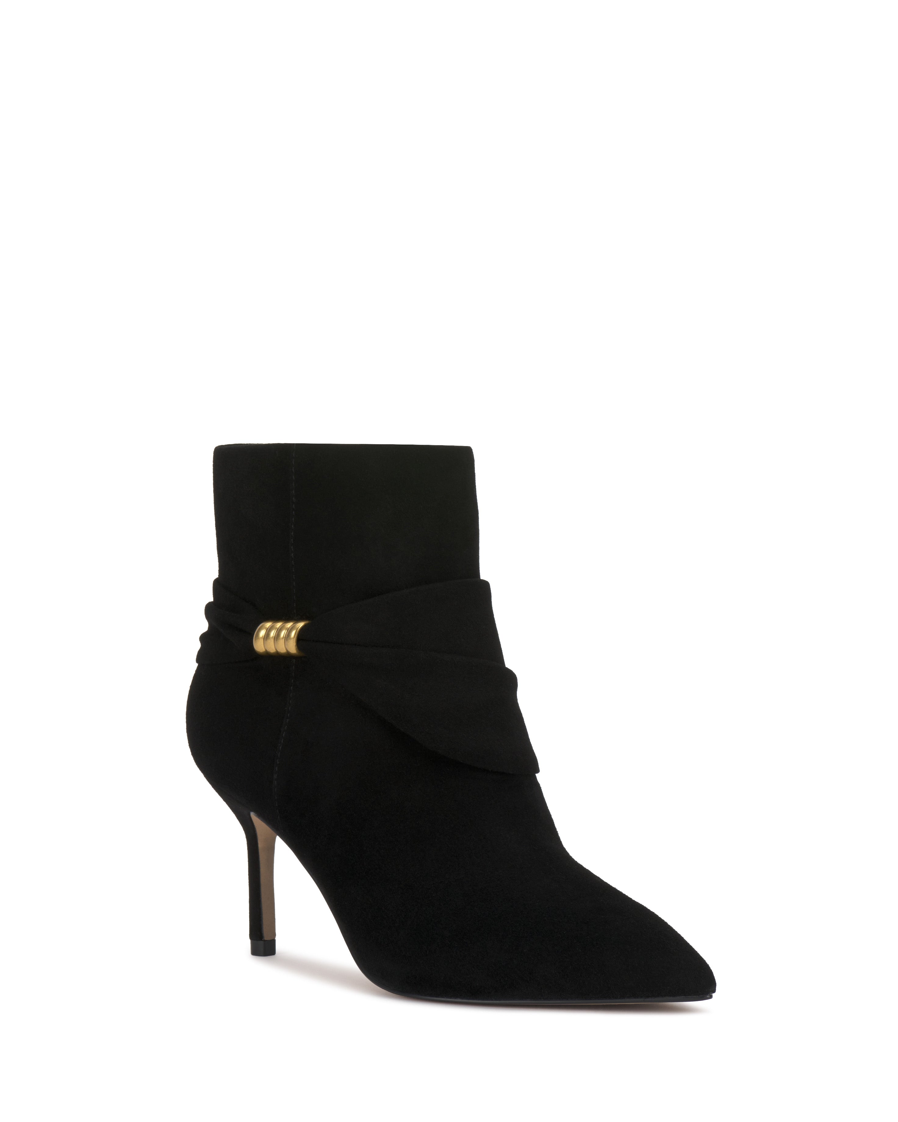 The Murlea Bootie by Vince Camuto is a black suede ankle boot featuring a pointed toe, stiletto heel, wraparound detail, and a small gold accent on the side.