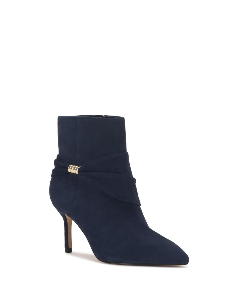 The Murlea Bootie by Vince Camuto features navy blue suede, a pointed toe, angled mid-heel, ankle wrap detail, and a small gold side embellishment.