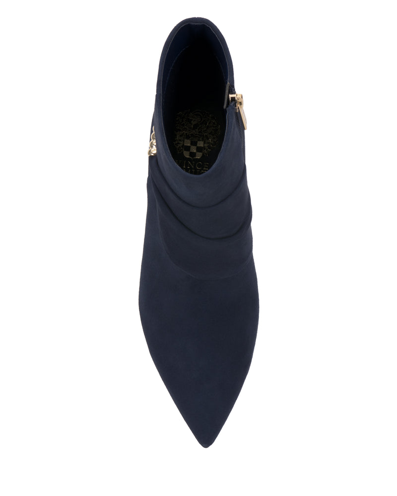 Top view of the Vince Camuto Murlea Bootie in dark blue, featuring a pointed toe, side zipper, subtle material folds, and an inner sole with a gold decorative design.