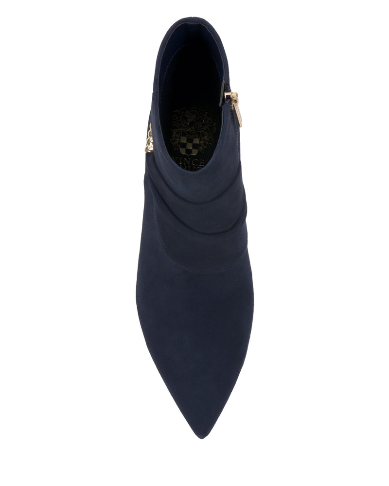 Top view of the Vince Camuto Murlea Bootie in navy blue suede, featuring a pointed toe, subtle pleats, gathered ankle design, and a gold side zipper.