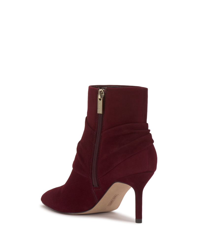 The Murlea Bootie by Vince Camuto features burgundy suede, a pointed toe, side zipper, pleated detail, and a slim high heel, displayed on a white background.