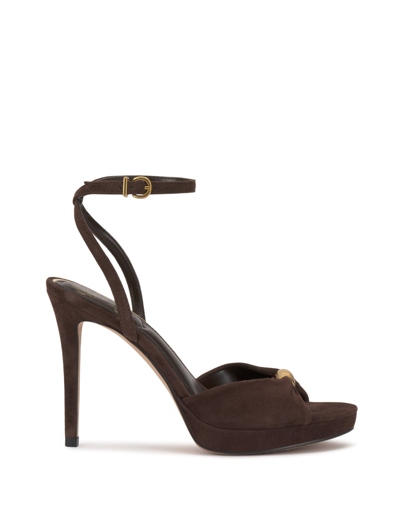 The Vince Camuto Neala Sandal is a dark brown suede high-heeled platform with an ankle strap, gold buckle, and peep-toe design, shown on a white background.