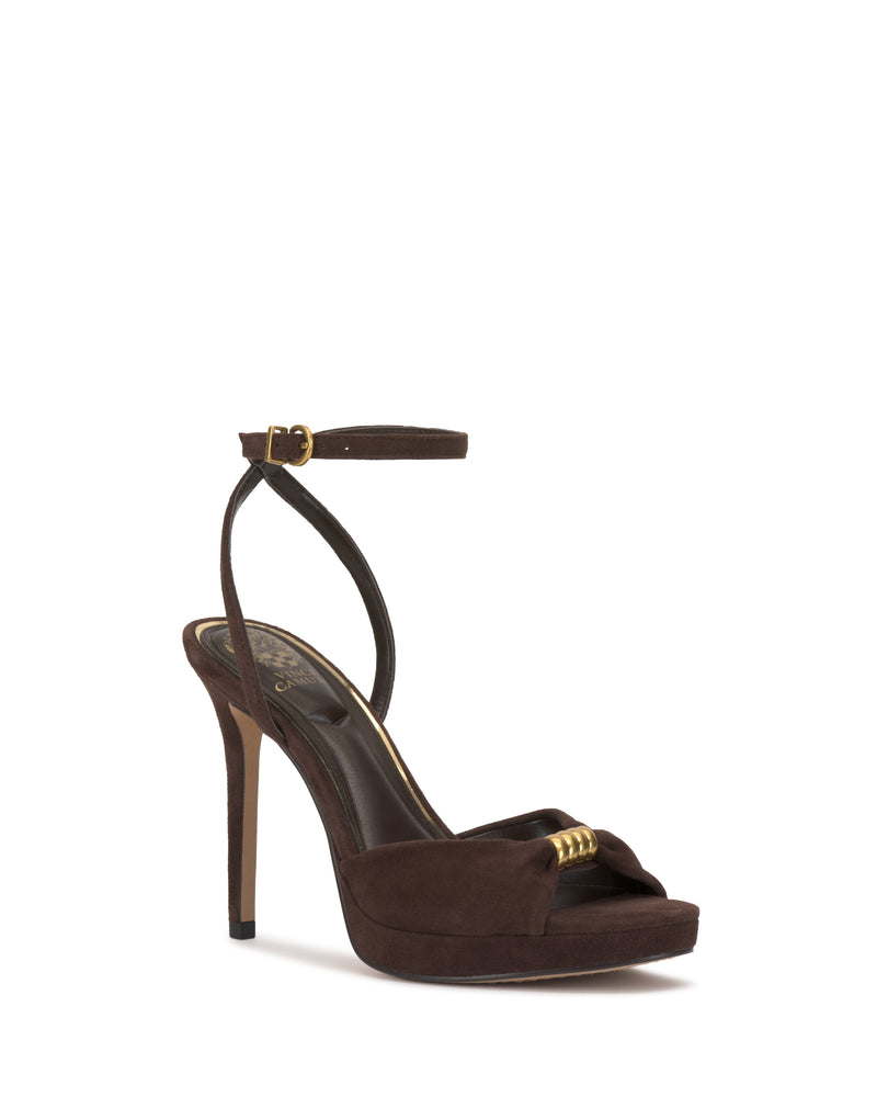 The Neala Sandal by Vince Camuto is a brown high-heeled platform sandal featuring an open toe, ankle strap with gold buckle, and gold accent on the front strap.