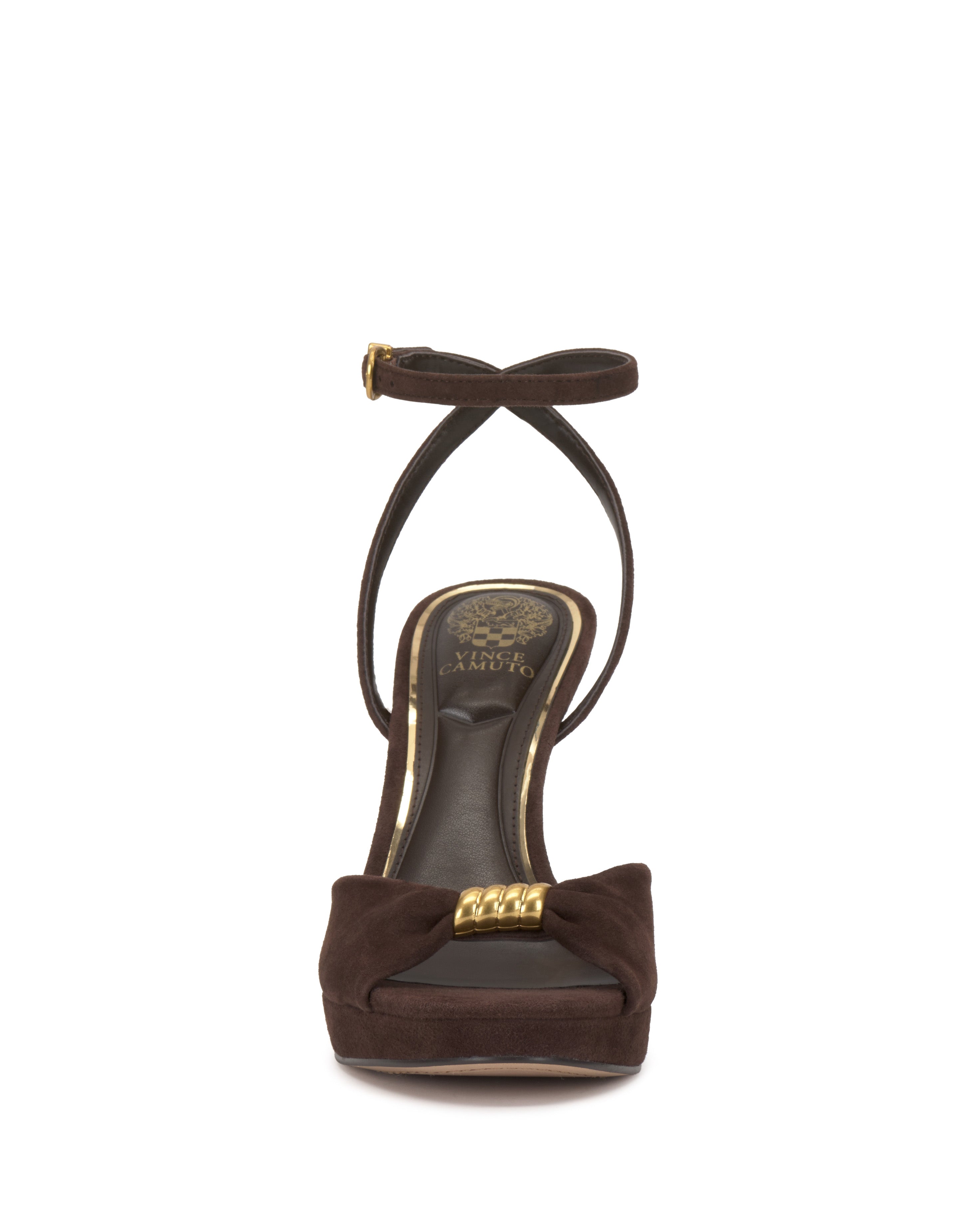 Front view of the Vince Camuto Neala Sandal in brown, featuring a high heel, ankle strap with gold buckle detail, bow accent on the toe, gold decorative elements, and a dark sole.
