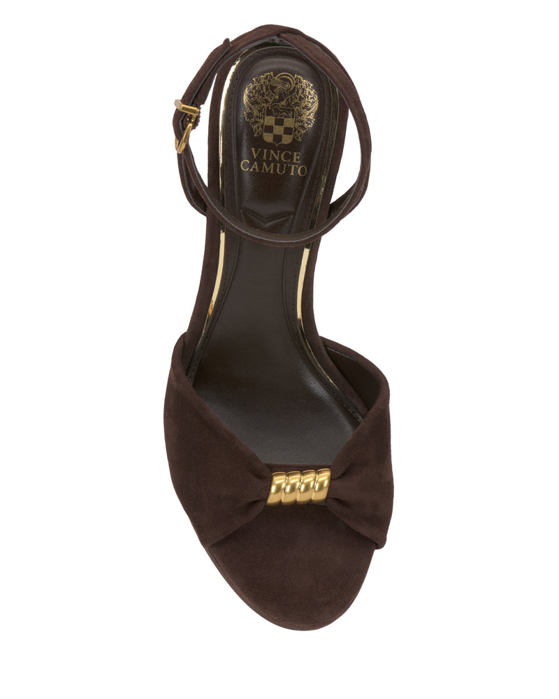 The Vince Camuto Neala Sandal is a brown suede open-toe style with an ankle strap, a gold buckle, and a gold chain accent on the toe strap, shown from above.