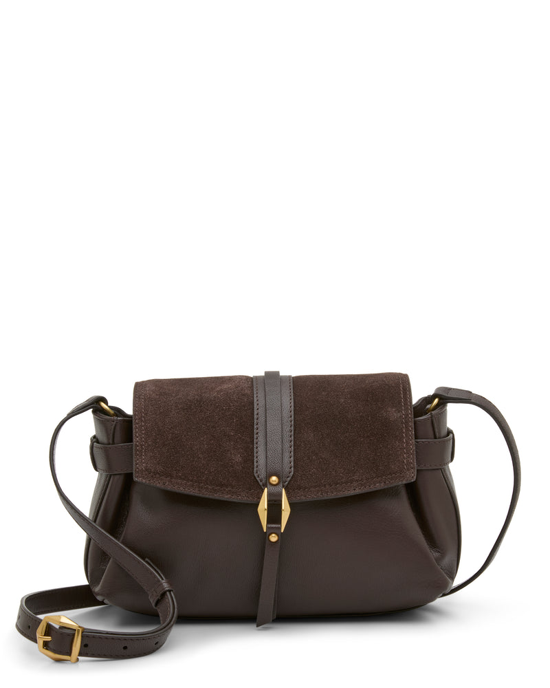 The Vince Camuto Nelly Crossbody Bag in dark brown leather features a suede flap, gold buckle detail, and an adjustable strap. Displayed against a plain white background, this stylish accessory is the perfect complement to any outfit.