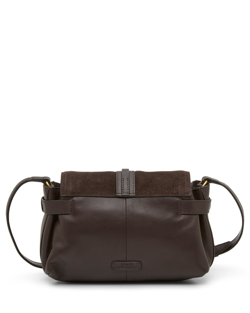 The Vince Camuto Nelly Crossbody Bag features dark brown leather with a matching suede flap and an adjustable shoulder strap, displayed against a white background for an elegant fashion accessory.