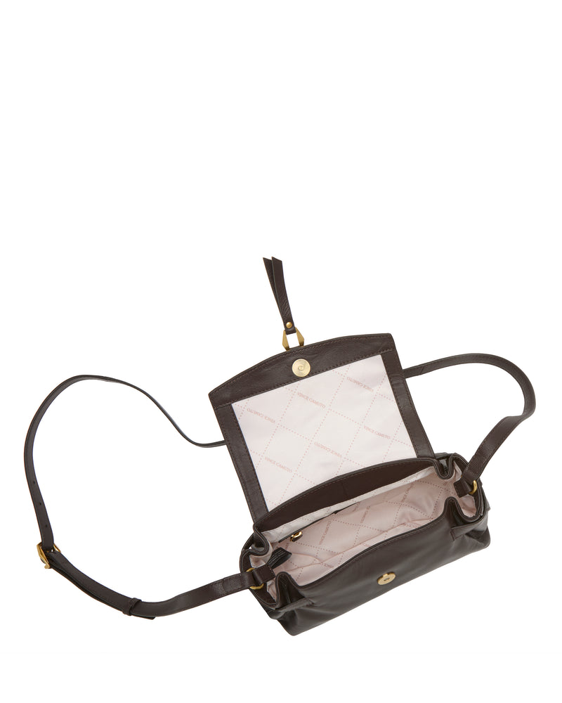 The Vince Camuto Nelly Crossbody Bag is displayed in dark brown leather with an adjustable strap, gold-tone hardware on the flap and strap, and a light-colored quilted interior that doubles as a jewelry organizer—making it an essential fashion accessory.