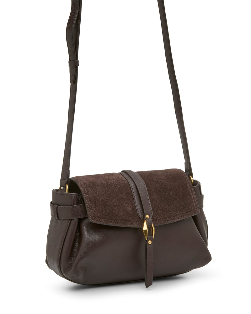 A Vince Camuto Nelly Crossbody Bag in dark brown leather, featuring a suede flap, gold clasp, and adjustable strap, is displayed at a three-quarter angle on a white background.