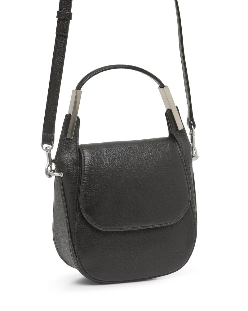 A black leather Noli Crossbody Bag by Vince Camuto, featuring a short top handle and a long adjustable strap. This stylish bag is designed with a front flap closure and sleek silver hardware accents.