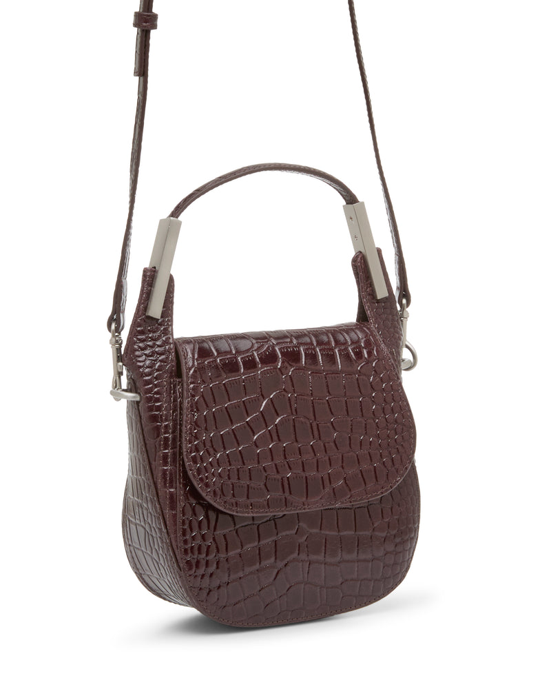 The Vince Camuto Noli Crossbody Bag is a small, dark brown, crocodile-patterned leather crossbody featuring a flap closure, short top handle, metal accents, and a long shoulder strap—making it an effortlessly stylish accessory.