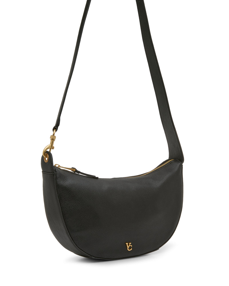 The Orlie Crossbody Bag by Vince Camuto is a sophisticated black leather shoulder bag featuring a gold zipper, a matching gold logo on the front, and an adjustable strap. This durable accessory combines everyday elegance with functional style.
