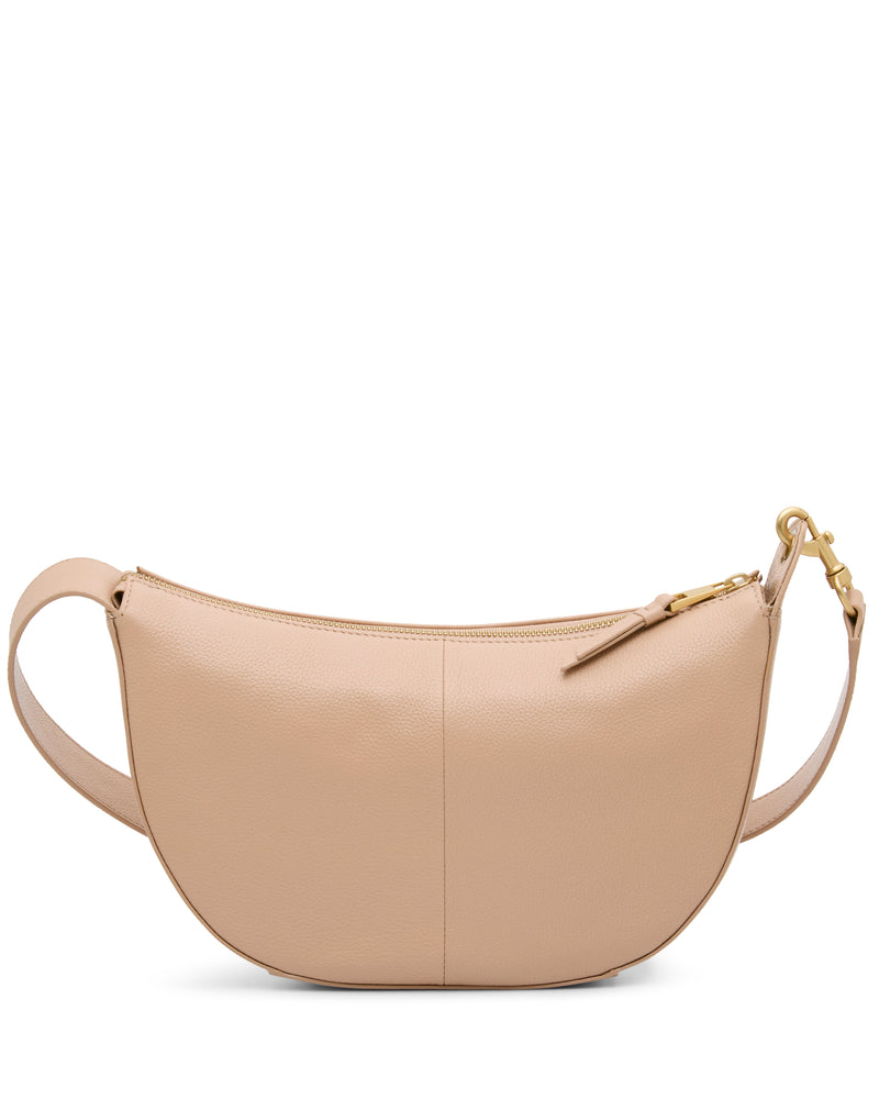 The Vince Camuto Orlie Crossbody Bag, pictured against a white background, is a stylish beige leather accessory with a crescent shape, gold zipper, and hardware that can be worn as both a shoulder or crossbody bag.